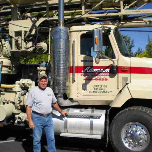 Well drilling contractor standing by work truck